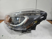 Load image into Gallery viewer, This image shows the left-side Xenon headlight for the Mercedes-Benz CLA Class C117, featuring original OEM quality with part number A1179065100. The headlight is a used but genuine component, designed to perfectly fit the left side of the CLA C117 model. It includes the factory-built Xenon lighting system and showcases the durable construction expected from Mercedes-Benz parts.