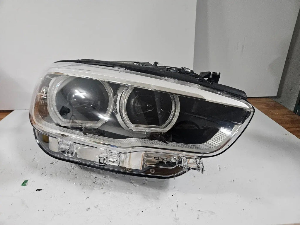This image displays the right-side LED headlight for the BMW 1 Series F20 and F21 LCI (facelift) models, featuring OEM genuine quality with part number 7414142. This used original headlamp is engineered for a precise fit on the facelifted 1 Series, offering bright LED illumination, modern styling, and reliable performance from an authentic BMW component