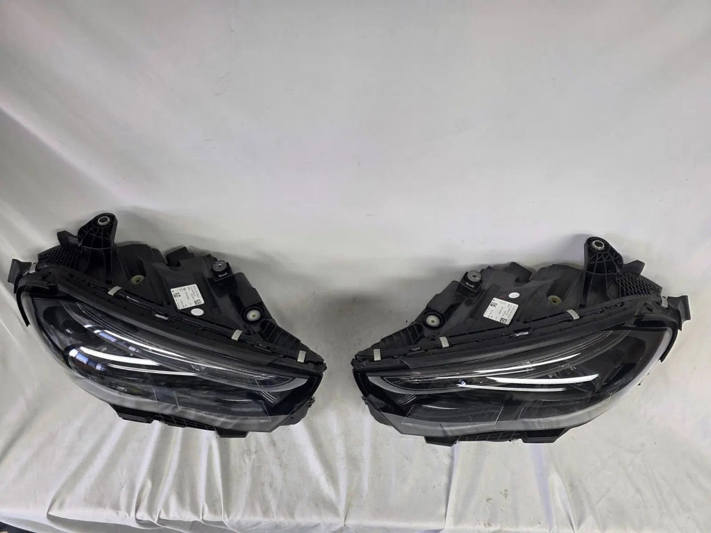 This image showcases the OEM genuine DIGITAL LIGHT headlights for the Mercedes-Benz E-Class W214, available for both right and left sides with part numbers A2149066102 (right) and A2149066202 (left). These advanced headlamps are original Mercedes-Benz components designed for the W214 model, offering cutting-edge DIGITAL LIGHT technology that enhances driving safety and precision lighting. The headlights are used but maintain high-quality OEM standards and are ideal replacements for the corresponding side.