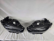 Load image into Gallery viewer, This image showcases the OEM genuine DIGITAL LIGHT headlights for the Mercedes-Benz E-Class W214, available for both right and left sides with part numbers A2149066102 (right) and A2149066202 (left). These advanced headlamps are original Mercedes-Benz components designed for the W214 model, offering cutting-edge DIGITAL LIGHT technology that enhances driving safety and precision lighting. The headlights are used but maintain high-quality OEM standards and are ideal replacements for the corresponding side.