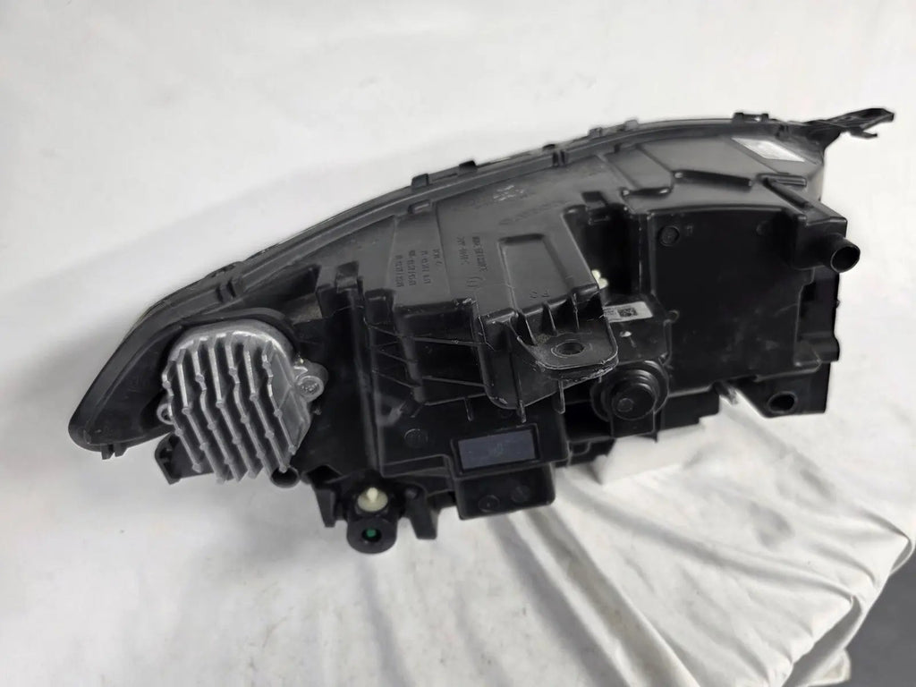 This image features the left-side Xenon headlight for the Volvo XC90, showcasing OEM genuine quality with part number 32404715. This used original headlamp is designed for accurate fitment and delivers powerful Xenon illumination, ensuring optimal visibility, durability, and premium performance for the XC90 luxury SUV