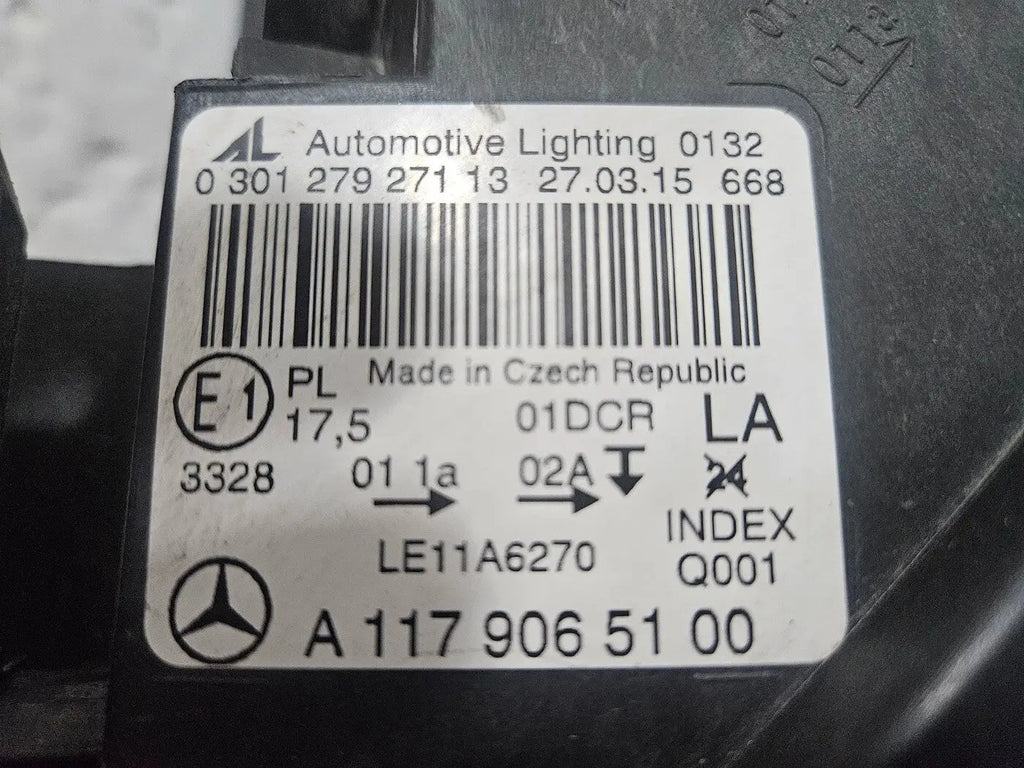 This image shows the left-side Xenon headlight for the Mercedes-Benz CLA Class C117, featuring original OEM quality with part number A1179065100. The headlight is a used but genuine component, designed to perfectly fit the left side of the CLA C117 model. It includes the factory-built Xenon lighting system and showcases the durable construction expected from Mercedes-Benz parts.