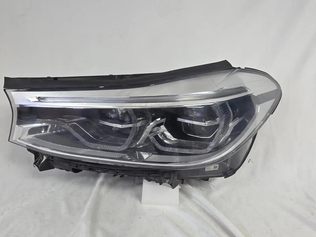 This image shows the left-side Adaptive LED headlight (ICON design) for the BMW 6 Series GT G32 model, featuring OEM genuine quality with part number 7496443. This used original headlamp is designed to deliver advanced Adaptive LED lighting with BMW’s ICON styling, offering precise fitment, enhanced road illumination, and premium performance for the 6 Series Gran Turismo.