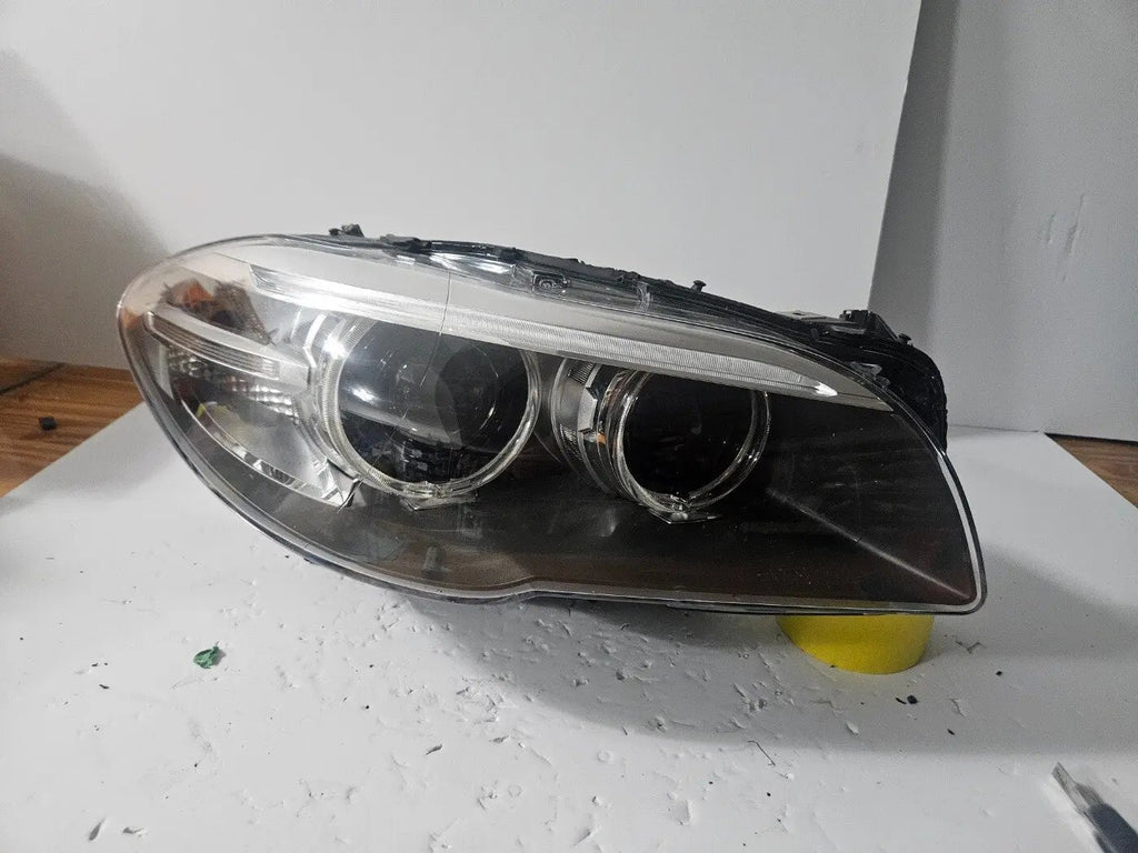 This image displays the right-side Xenon headlight for the BMW 5 Series F18 LCI, F10 LCI, and F11 LCI models, featuring OEM genuine quality with part number 7343912. This used original headlamp is designed specifically for the facelifted (LCI) versions, offering precise fitment, powerful Xenon illumination, and the premium durability expected from authentic BMW components.