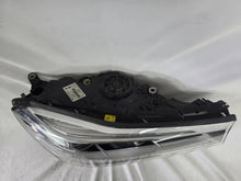 Load image into Gallery viewer, Used genuine BMW Laser headlight for 7 Series models G11 and G12. This right-side OEM headlamp, part number 7465606, features advanced laser lighting technology for superior visibility and performance. The image shows the original BMW right laser headlight in used condition, highlighting the detailed lens design, housing structure, and connector ports — ideal for high-end replacement or repair on compatible 7 Series vehicles.