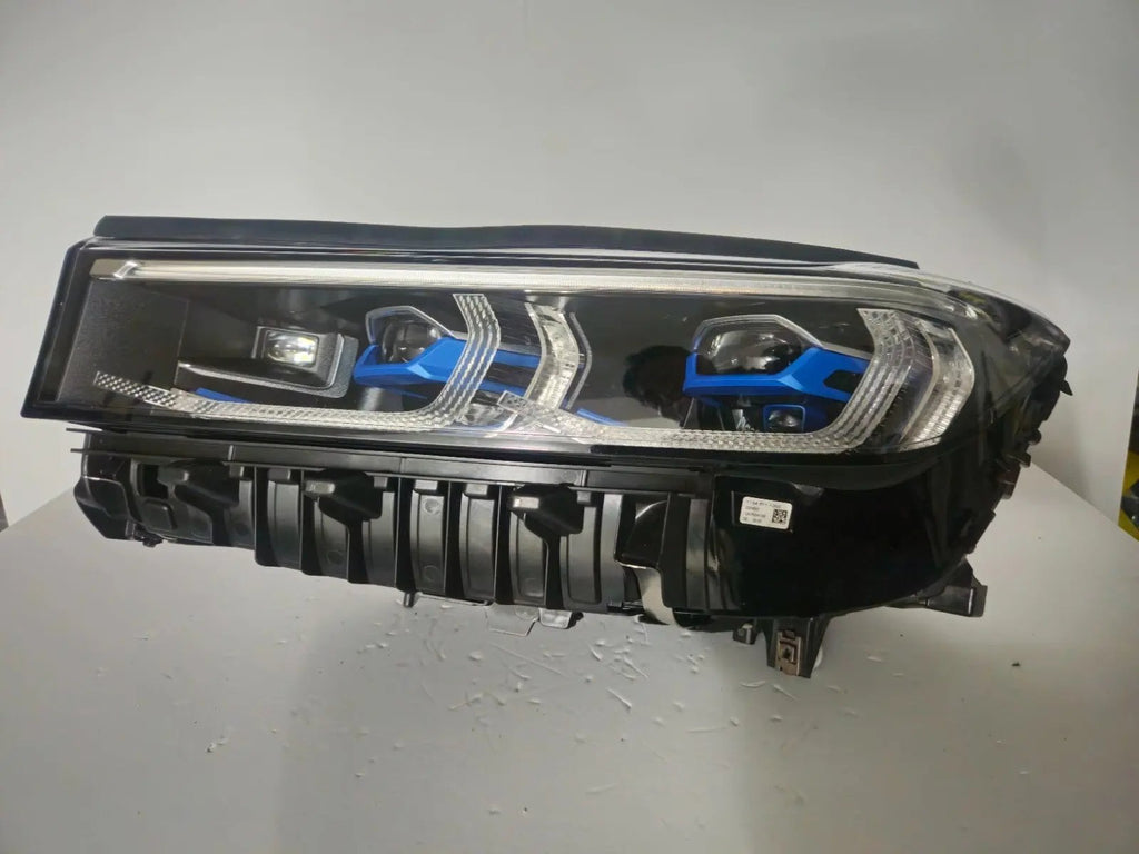 This image features the left-side Laser headlight for the BMW 7 Series G11 LCI and G12 LCI models, with OEM genuine quality and part number 9450229. Specifically designed for the facelifted (LCI) versions of the G11 and G12, this used original headlamp offers cutting-edge BMW Laserlight technology, precision fitment, and exceptional nighttime visibility, perfectly aligning with the luxury and performance of the 7 Series