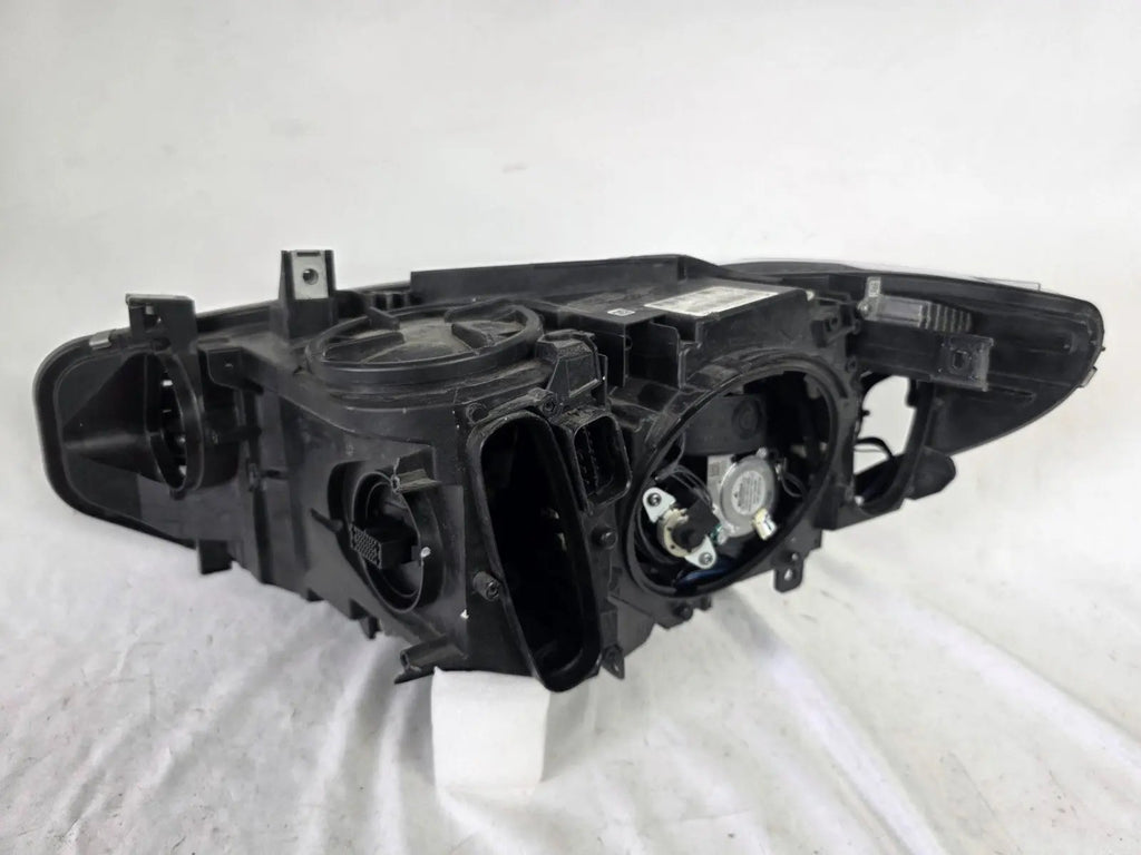Genuine used BMW Adaptive LED headlight for 4 Series models F32, F33, F36, F80 LCI, F82, and F83. This right-side OEM headlamp, part number 7377842, is designed with adaptive lighting technology for improved visibility and performance. The image highlights the complete original headlight unit in used condition, including the clear lens, mounting points, and electrical connectors — ideal for replacement on compatible BMW models.