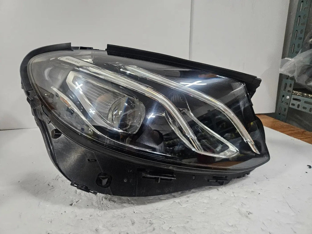 This image features the right-side LED High Performance headlight for the Mercedes-Benz E-Class W213, showcasing OEM genuine quality with part number A2139064004. Specifically designed for the W213 model, this used headlight offers high-performance LED illumination and is an original Mercedes-Benz component, ensuring precise fit and reliable functionality
