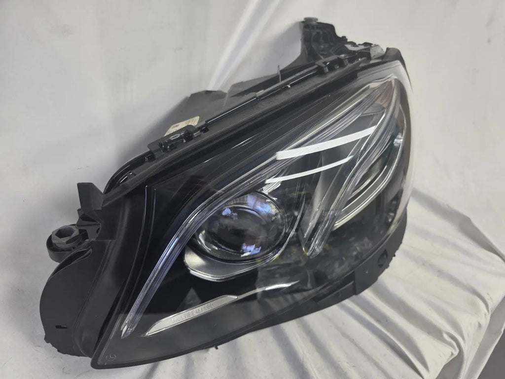 This image displays the left-side Multibeam LED headlight with blue accents for the Mercedes-Benz E-Class W213, featuring OEM genuine quality and part number A2139066504. This original used headlamp is designed for precise fitment on the W213 model, offering advanced Multibeam LED technology with distinctive blue detailing for high-performance adaptive illumination and premium styling