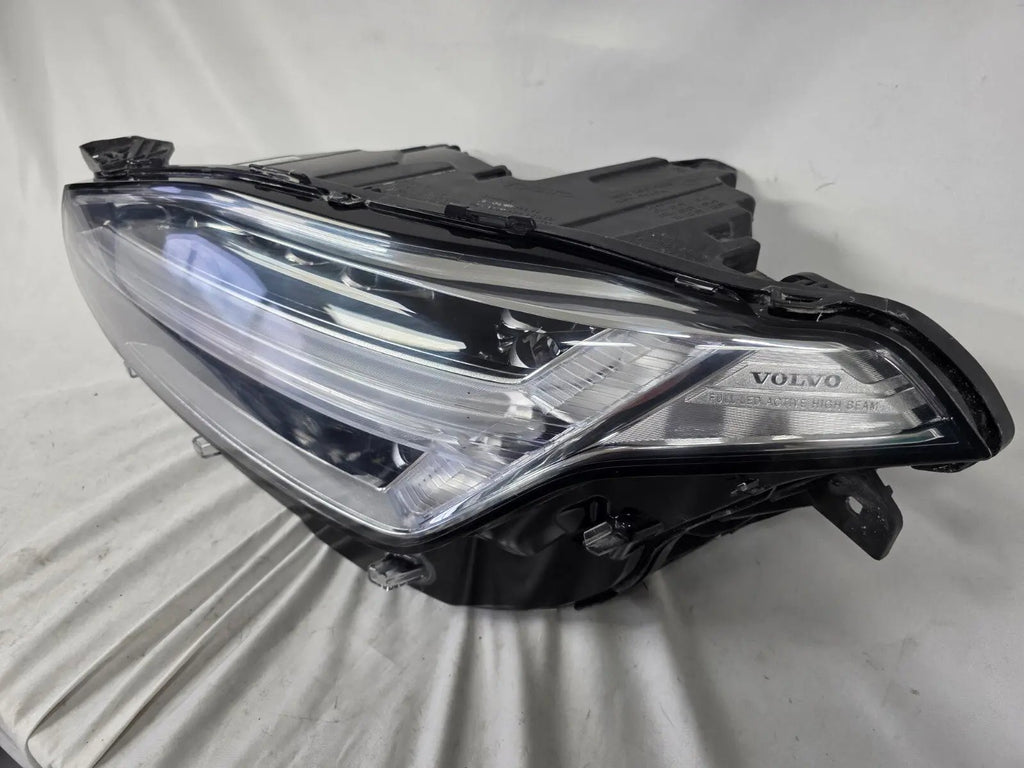 This image features the left-side Xenon headlight for the Volvo XC90, showcasing OEM genuine quality with part number 32404715. This used original headlamp is designed for accurate fitment and delivers powerful Xenon illumination, ensuring optimal visibility, durability, and premium performance for the XC90 luxury SUV