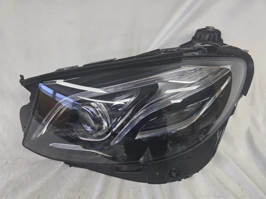 This image displays the left-side Multibeam LED headlight with blue accents for the Mercedes-Benz E-Class W213, featuring OEM genuine quality and part number A2139066504. This original used headlamp is designed for precise fitment on the W213 model, offering advanced Multibeam LED technology with distinctive blue detailing for high-performance adaptive illumination and premium styling