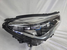 Load image into Gallery viewer, Used genuine BMW Laser headlight for 7 Series models G11 and G12. This right-side OEM headlamp, part number 7465606, features advanced laser lighting technology for superior visibility and performance. The image shows the original BMW right laser headlight in used condition, highlighting the detailed lens design, housing structure, and connector ports — ideal for high-end replacement or repair on compatible 7 Series vehicles.