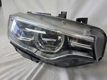 Load image into Gallery viewer, Genuine used BMW Adaptive LED headlight for 4 Series models F32, F33, F36, F80 LCI, F82, and F83. This right-side OEM headlamp, part number 7377842, is designed with adaptive lighting technology for improved visibility and performance. The image highlights the complete original headlight unit in used condition, including the clear lens, mounting points, and electrical connectors — ideal for replacement on compatible BMW models.