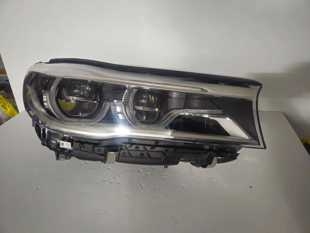 This image features the right-side Adaptive LED headlight (ICON design) for the BMW 7 Series G11 and G12 models, showcasing OEM genuine quality with part number 7408710. This used original headlamp offers BMW’s signature Adaptive LED with ICON styling, providing dynamic lighting performance, precise fitment, and premium functionality tailored for the luxury 7 Series lineup.