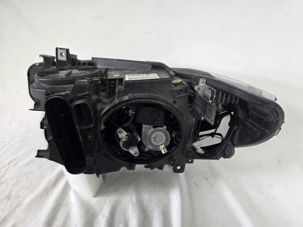 Genuine used BMW Adaptive LED headlight for 4 Series models F32, F33, F36, F80 LCI, F82, and F83. This right-side OEM headlamp, part number 7377842, is designed with adaptive lighting technology for improved visibility and performance. The image highlights the complete original headlight unit in used condition, including the clear lens, mounting points, and electrical connectors — ideal for replacement on compatible BMW models.