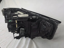 Load image into Gallery viewer, Genuine OEM BMW Laser headlight for 5 Series models G30, G31, and F90 LCI (facelift). This left-side headlamp, part number 5A388D5, is equipped with advanced laser lighting technology for superior visibility and precision on the road. The image displays the original left laser headlight in used condition, clearly showing the lens structure, cooling fins, mounting points, and connector ports — ideal for OEM replacement on compatible BMW 5 Series LCI vehicles.
