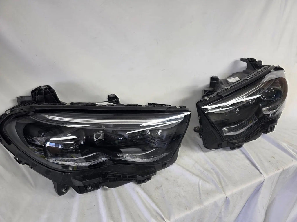 This image showcases the OEM genuine DIGITAL LIGHT headlights for the Mercedes-Benz E-Class W214, available for both right and left sides with part numbers A2149066102 (right) and A2149066202 (left). These advanced headlamps are original Mercedes-Benz components designed for the W214 model, offering cutting-edge DIGITAL LIGHT technology that enhances driving safety and precision lighting. The headlights are used but maintain high-quality OEM standards and are ideal replacements for the corresponding side.
