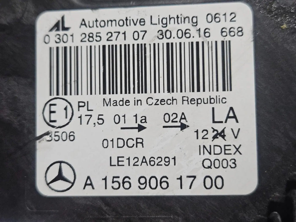 Genuine used Mercedes-Benz Bi-Xenon headlight for GLA-Class model X156. This left-side (LH) OEM headlamp, part number A1569061700, features Bi-Xenon lighting technology for enhanced night visibility and a focused beam pattern. The image shows the original left headlight in used condition, highlighting the lens clarity, projector unit, mounting brackets, and electrical connector — ideal for replacing a damaged headlamp on compatible Mercedes-Benz GLA X156 vehicles.