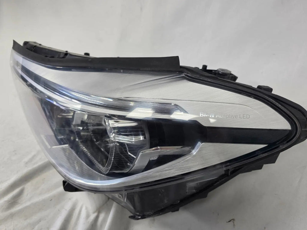 This image shows the left-side Adaptive LED headlight (ICON design) for the BMW 6 Series GT G32 model, featuring OEM genuine quality with part number 7496443. This used original headlamp is designed to deliver advanced Adaptive LED lighting with BMW’s ICON styling, offering precise fitment, enhanced road illumination, and premium performance for the 6 Series Gran Turismo.