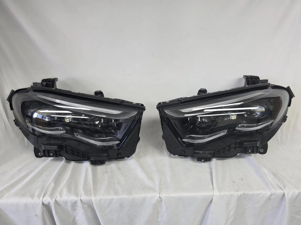 This image showcases the OEM genuine DIGITAL LIGHT headlights for the Mercedes-Benz E-Class W214, available for both right and left sides with part numbers A2149066102 (right) and A2149066202 (left). These advanced headlamps are original Mercedes-Benz components designed for the W214 model, offering cutting-edge DIGITAL LIGHT technology that enhances driving safety and precision lighting. The headlights are used but maintain high-quality OEM standards and are ideal replacements for the corresponding side.