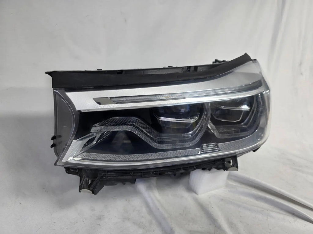 This image shows the left-side Adaptive LED headlight (ICON design) for the BMW 6 Series GT G32 model, featuring OEM genuine quality with part number 7496443. This used original headlamp is designed to deliver advanced Adaptive LED lighting with BMW’s ICON styling, offering precise fitment, enhanced road illumination, and premium performance for the 6 Series Gran Turismo.