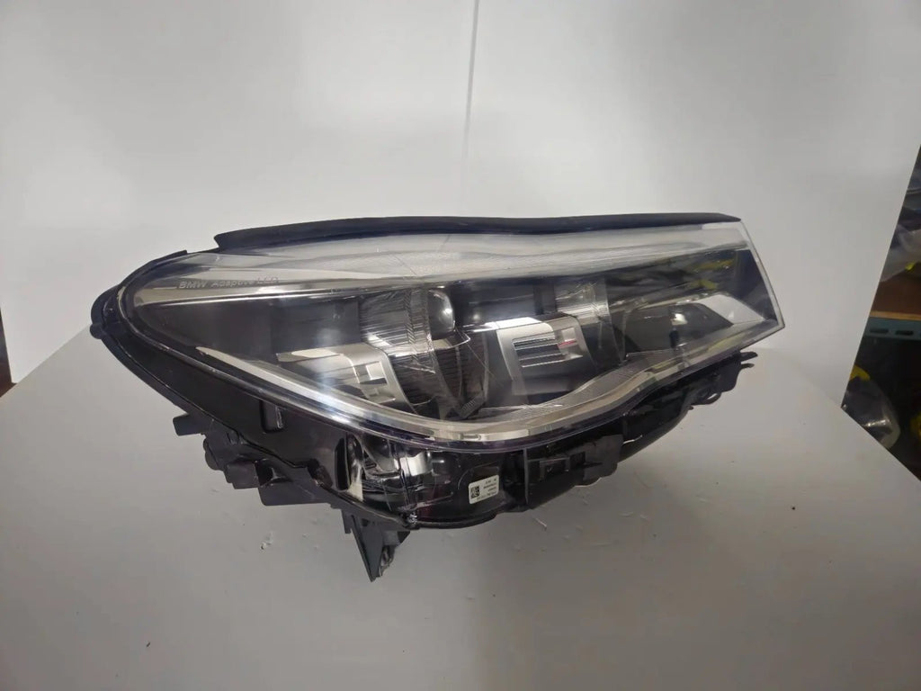 This image features the right-side Adaptive LED headlight (ICON design) for the BMW 7 Series G11 and G12 models, showcasing OEM genuine quality with part number 7408710. This used original headlamp offers BMW’s signature Adaptive LED with ICON styling, providing dynamic lighting performance, precise fitment, and premium functionality tailored for the luxury 7 Series lineup.