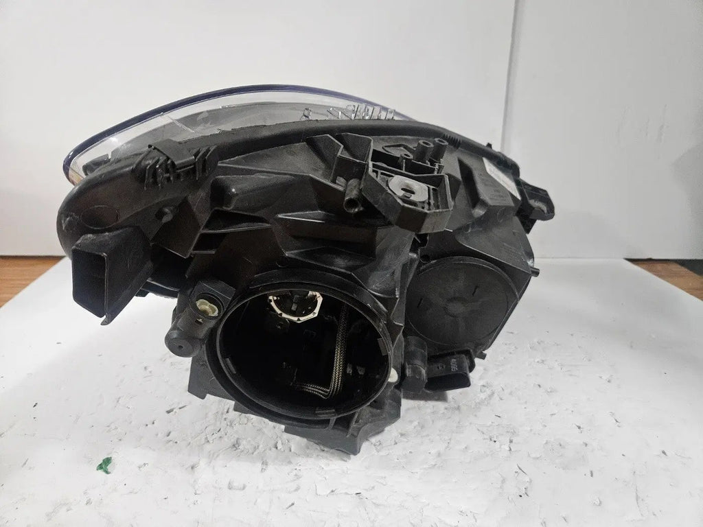 This image shows the left-side Xenon headlight for the Mercedes-Benz CLA Class C117, featuring original OEM quality with part number A1179065100. The headlight is a used but genuine component, designed to perfectly fit the left side of the CLA C117 model. It includes the factory-built Xenon lighting system and showcases the durable construction expected from Mercedes-Benz parts.