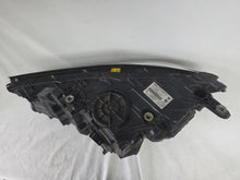 Load image into Gallery viewer, Used genuine BMW Laser headlight for 7 Series models G11 and G12. This right-side OEM headlamp, part number 7465606, features advanced laser lighting technology for superior visibility and performance. The image shows the original BMW right laser headlight in used condition, highlighting the detailed lens design, housing structure, and connector ports — ideal for high-end replacement or repair on compatible 7 Series vehicles.
