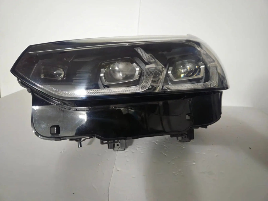 This image features the left-side Adaptive LED headlight for BMW models including iX3 G08, X3 G01, X3 M F97, X4 G02, and X4 M F98, with OEM genuine quality and part number 5A29203. This used original headlamp provides precise fitment and BMW’s advanced Adaptive LED technology, ensuring enhanced visibility, dynamic beam control, and premium styling for these performance SUVs.