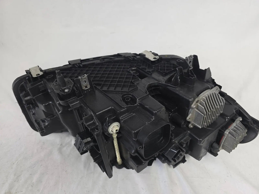 Genuine OEM BMW Laser headlight for 5 Series models G30, G31, and F90 LCI (facelift). This left-side headlamp, part number 5A388D5, is equipped with advanced laser lighting technology for superior visibility and precision on the road. The image displays the original left laser headlight in used condition, clearly showing the lens structure, cooling fins, mounting points, and connector ports — ideal for OEM replacement on compatible BMW 5 Series LCI vehicles.