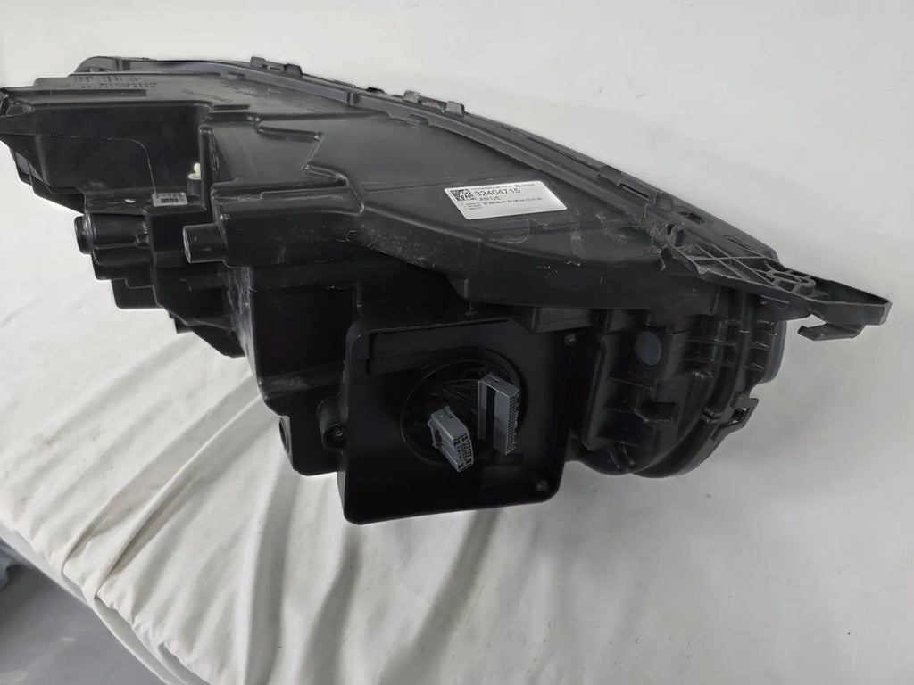 This image features the left-side Xenon headlight for the Volvo XC90, showcasing OEM genuine quality with part number 32404715. This used original headlamp is designed for accurate fitment and delivers powerful Xenon illumination, ensuring optimal visibility, durability, and premium performance for the XC90 luxury SUV