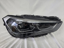 Load image into Gallery viewer, Used genuine BMW Adaptive LED headlight for X1 F48 LCI (facelift) model. This right-side OEM headlamp, part number 5A01178, is equipped with adaptive lighting technology for improved night visibility and cornering performance. The image displays the original right Adaptive LED headlight in used condition, showing the clear lens, mounting brackets, and electrical connectors — an ideal OEM replacement for BMW X1 F48 LCI vehicles.