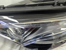 Load image into Gallery viewer, This image displays the left-side Multibeam LED headlight with blue accents for the Mercedes-Benz E-Class W213, featuring OEM genuine quality and part number A2139066504. This original used headlamp is designed for precise fitment on the W213 model, offering advanced Multibeam LED technology with distinctive blue detailing for high-performance adaptive illumination and premium styling