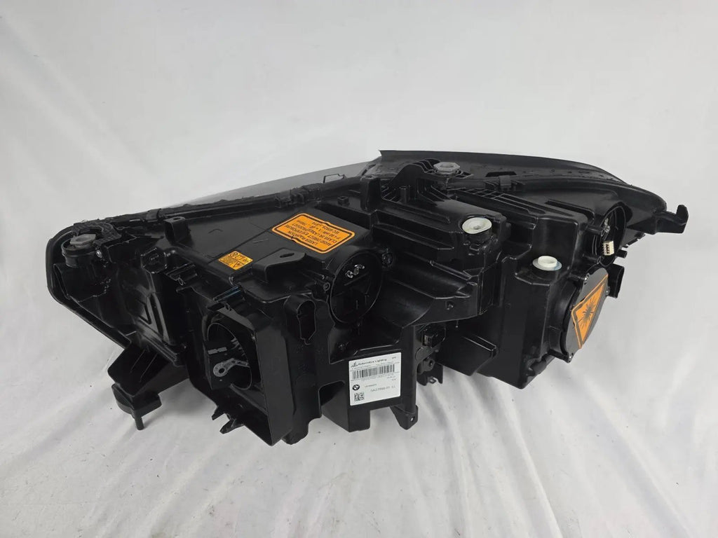 This image displays the right-side Laser headlight for BMW models X5 G05, X5 M F95, X6 G06, and X6 M F96, featuring OEM genuine quality with part number 5A27998. This used original headlamp delivers cutting-edge BMW Laserlight technology, offering enhanced night visibility, precise fitment, and a sleek, high-performance design tailored for these luxury SUV models.