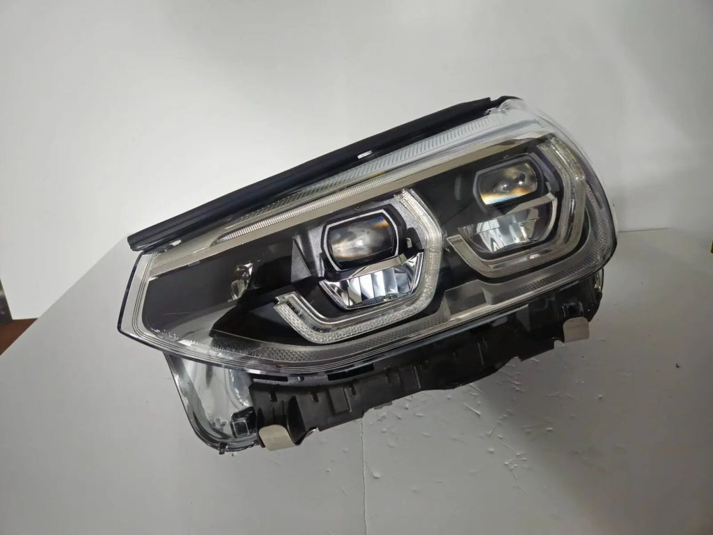 This image shows the left-side ICON Adaptive LED headlight for BMW models iX3 G08, X3 G01, X3 M F97, X4 G02, and X4 M F98, featuring OEM genuine quality with part number 7466119. This used original headlamp is designed to deliver BMW’s signature Adaptive LED lighting with ICON styling, ensuring precise fitment, enhanced visibility, and modern aesthetics for these high-performance models.