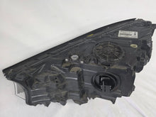 Load image into Gallery viewer, Used genuine BMW Laser headlight for 7 Series models G11 and G12. This right-side OEM headlamp, part number 7465606, features advanced laser lighting technology for superior visibility and performance. The image shows the original BMW right laser headlight in used condition, highlighting the detailed lens design, housing structure, and connector ports — ideal for high-end replacement or repair on compatible 7 Series vehicles.