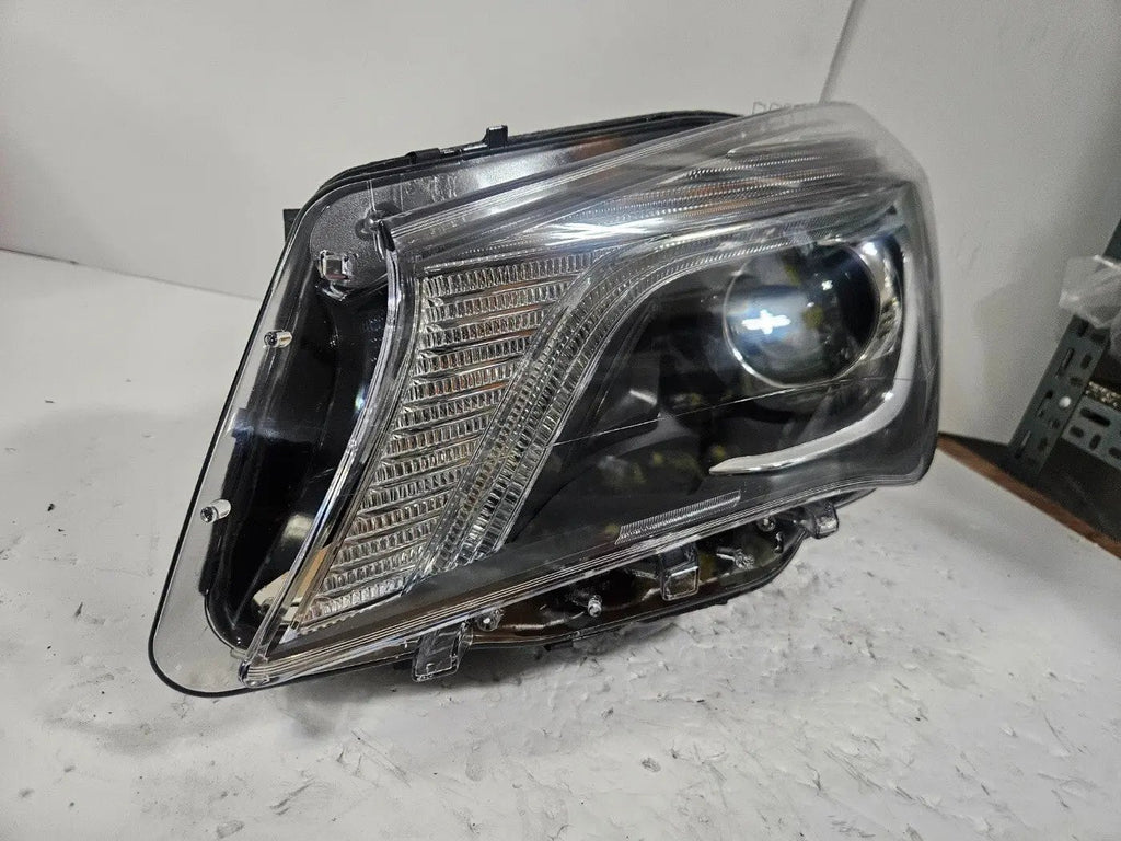 This image shows the left-side Xenon headlight for the Mercedes-Benz CLA Class C117, featuring original OEM quality with part number A1179065100. The headlight is a used but genuine component, designed to perfectly fit the left side of the CLA C117 model. It includes the factory-built Xenon lighting system and showcases the durable construction expected from Mercedes-Benz parts.