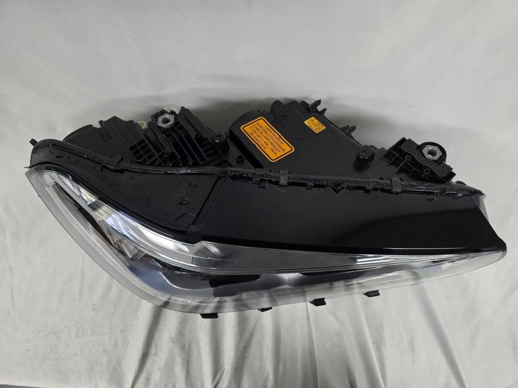 This image displays the right-side Laser headlight for BMW models X5 G05, X5 M F95, X6 G06, and X6 M F96, featuring OEM genuine quality with part number 5A27998. This used original headlamp delivers cutting-edge BMW Laserlight technology, offering enhanced night visibility, precise fitment, and a sleek, high-performance design tailored for these luxury SUV models.