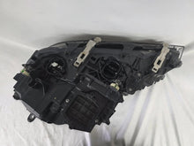 Load image into Gallery viewer, Used genuine BMW Laser headlight for 7 Series models G11 and G12. This right-side OEM headlamp, part number 7465606, features advanced laser lighting technology for superior visibility and performance. The image shows the original BMW right laser headlight in used condition, highlighting the detailed lens design, housing structure, and connector ports — ideal for high-end replacement or repair on compatible 7 Series vehicles.