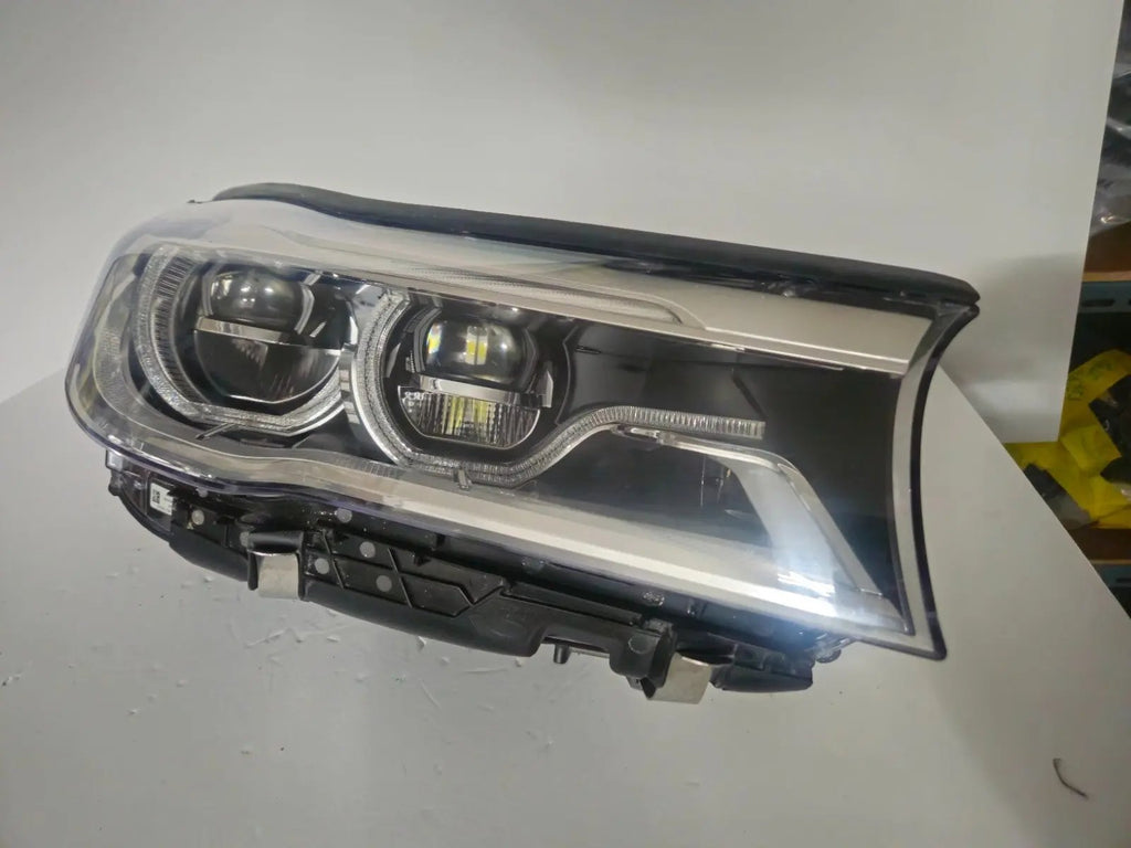This image features the right-side Adaptive LED headlight (ICON design) for the BMW 7 Series G11 and G12 models, showcasing OEM genuine quality with part number 7408710. This used original headlamp offers BMW’s signature Adaptive LED with ICON styling, providing dynamic lighting performance, precise fitment, and premium functionality tailored for the luxury 7 Series lineup.