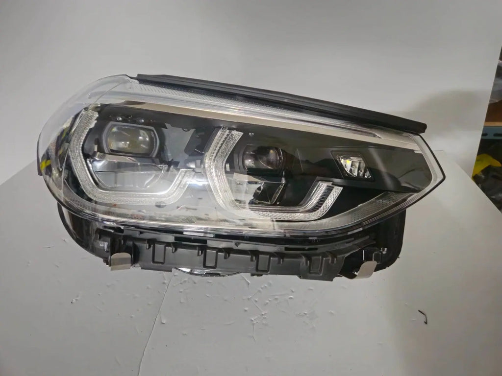 This image displays the right-side ICON Adaptive LED headlight for BMW models iX3 G08, X3 G01, X3 M F97, X4 G02, and X4 M F98, featuring OEM genuine quality with part number 7494052. This used original headlamp offers BMW’s advanced Adaptive LED with ICON design, delivering precise light distribution, dynamic styling, and perfect fitment for these specific models