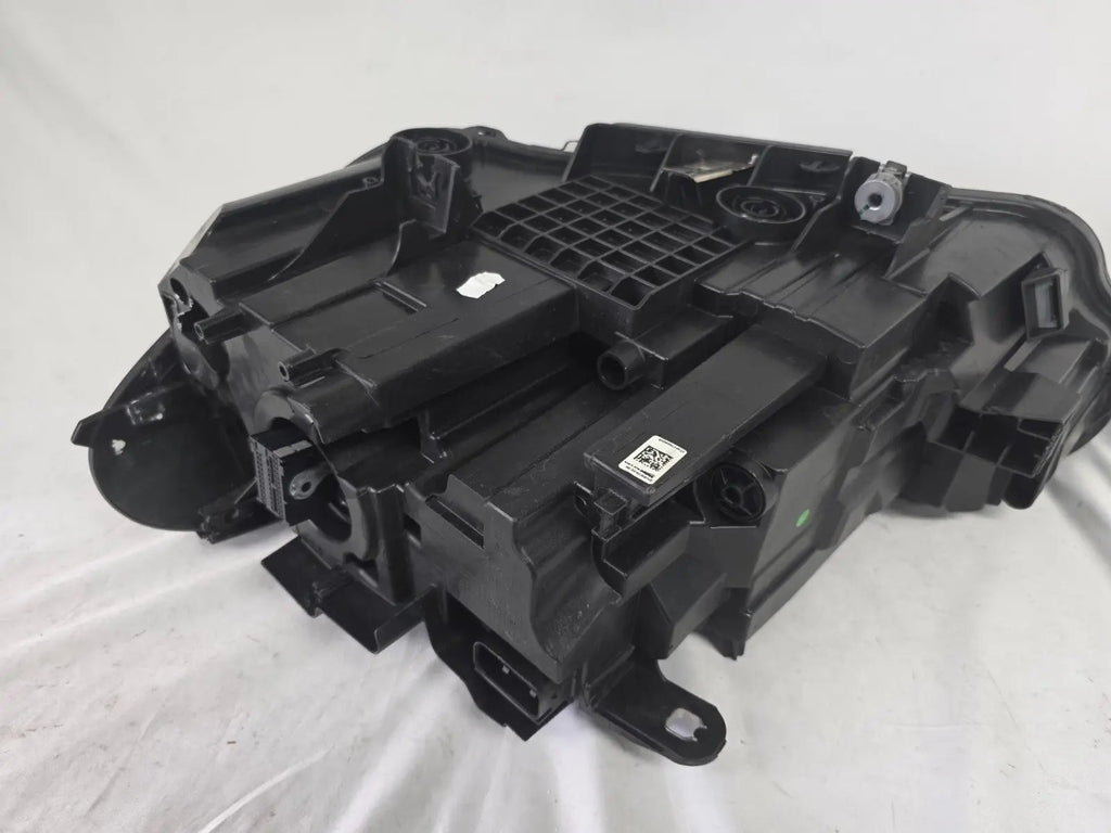 Used genuine BMW Adaptive LED headlight for X1 F48 LCI (facelift) model. This right-side OEM headlamp, part number 5A01178, is equipped with adaptive lighting technology for improved night visibility and cornering performance. The image displays the original right Adaptive LED headlight in used condition, showing the clear lens, mounting brackets, and electrical connectors — an ideal OEM replacement for BMW X1 F48 LCI vehicles.