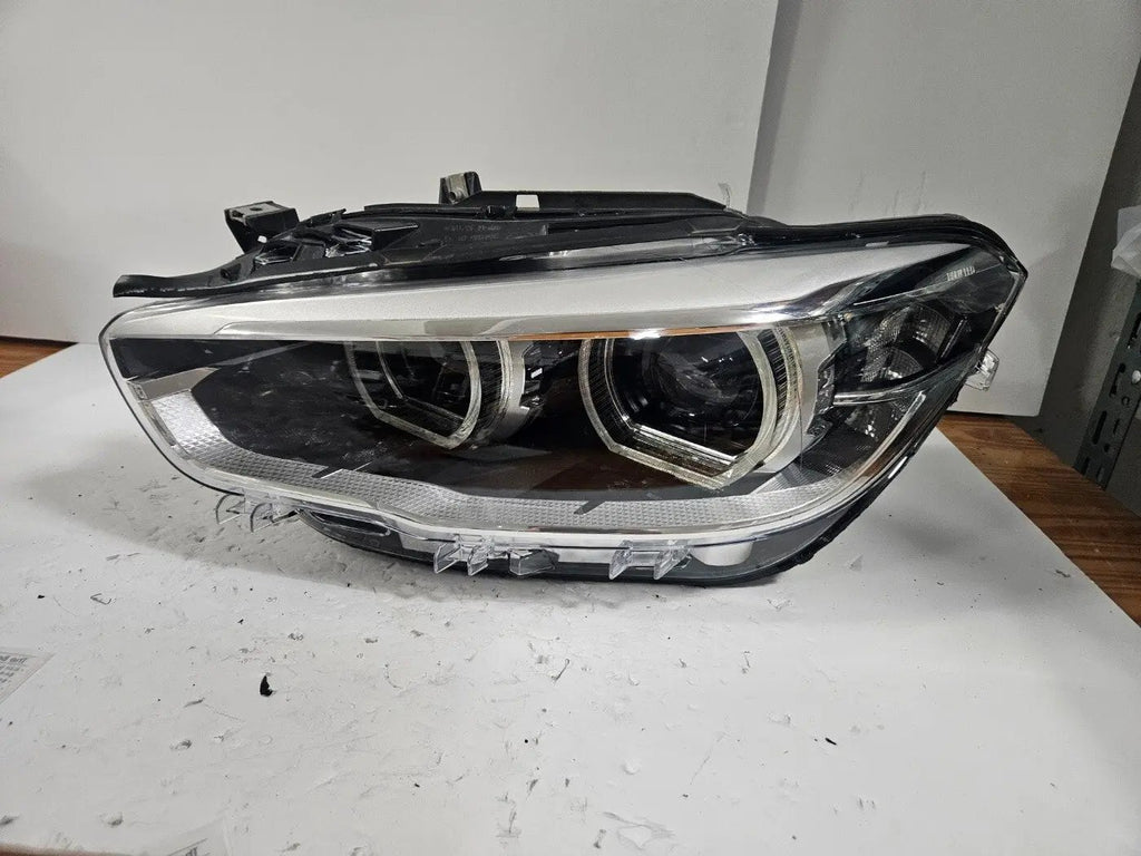 This image shows the left-side LED headlight for the BMW 1 Series F20 and F21 LCI (facelift) models, featuring OEM genuine quality with part number 7435777. This used original headlamp is specifically designed for the facelifted 1 Series, offering bright and efficient LED lighting, precise fitment, and the durability expected from authentic BMW components.