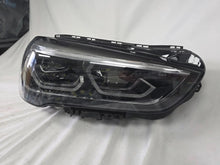 Load image into Gallery viewer, Used genuine BMW Adaptive LED headlight for X1 F48 LCI (facelift) model. This right-side OEM headlamp, part number 5A01178, is equipped with adaptive lighting technology for improved night visibility and cornering performance. The image displays the original right Adaptive LED headlight in used condition, showing the clear lens, mounting brackets, and electrical connectors — an ideal OEM replacement for BMW X1 F48 LCI vehicles.