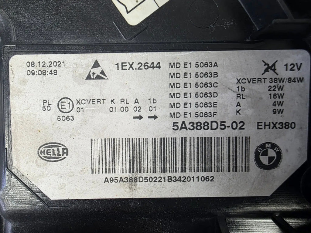 Genuine OEM BMW Laser headlight for 5 Series models G30, G31, and F90 LCI (facelift). This left-side headlamp, part number 5A388D5, is equipped with advanced laser lighting technology for superior visibility and precision on the road. The image displays the original left laser headlight in used condition, clearly showing the lens structure, cooling fins, mounting points, and connector ports — ideal for OEM replacement on compatible BMW 5 Series LCI vehicles.