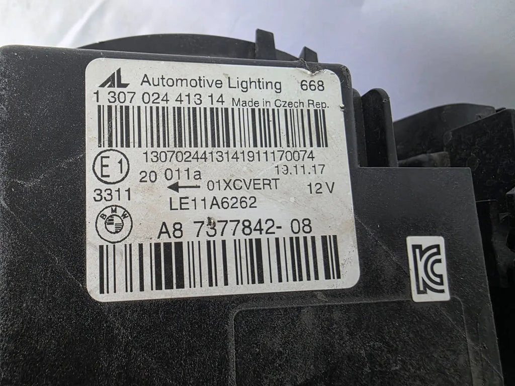 Genuine used BMW Adaptive LED headlight for 4 Series models F32, F33, F36, F80 LCI, F82, and F83. This right-side OEM headlamp, part number 7377842, is designed with adaptive lighting technology for improved visibility and performance. The image highlights the complete original headlight unit in used condition, including the clear lens, mounting points, and electrical connectors — ideal for replacement on compatible BMW models.