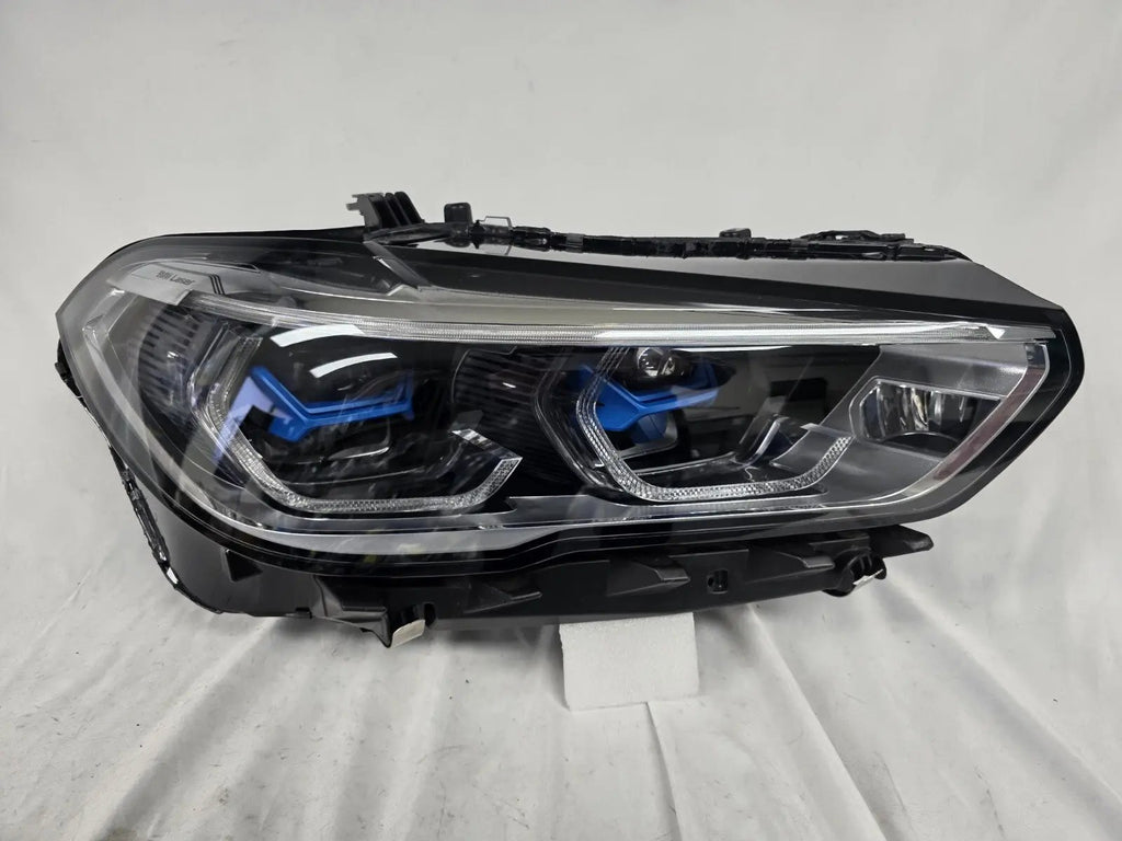 This image displays the right-side Laser headlight for BMW models X5 G05, X5 M F95, X6 G06, and X6 M F96, featuring OEM genuine quality with part number 5A27998. This used original headlamp delivers cutting-edge BMW Laserlight technology, offering enhanced night visibility, precise fitment, and a sleek, high-performance design tailored for these luxury SUV models.