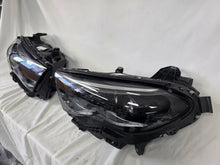 Load image into Gallery viewer, This image showcases the OEM genuine DIGITAL LIGHT headlights for the Mercedes-Benz E-Class W214, available for both right and left sides with part numbers A2149066102 (right) and A2149066202 (left). These advanced headlamps are original Mercedes-Benz components designed for the W214 model, offering cutting-edge DIGITAL LIGHT technology that enhances driving safety and precision lighting. The headlights are used but maintain high-quality OEM standards and are ideal replacements for the corresponding side.