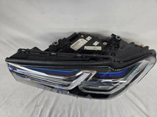 Load image into Gallery viewer, Genuine OEM BMW Laser headlight for 5 Series models G30, G31, and F90 LCI (facelift). This left-side headlamp, part number 5A388D5, is equipped with advanced laser lighting technology for superior visibility and precision on the road. The image displays the original left laser headlight in used condition, clearly showing the lens structure, cooling fins, mounting points, and connector ports — ideal for OEM replacement on compatible BMW 5 Series LCI vehicles.