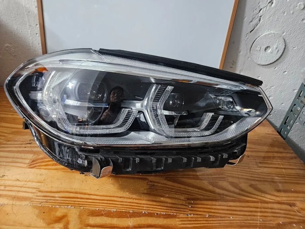 This image displays the right-side ICON Adaptive LED headlight for BMW models iX3 G08, X3 G01, X3 M F97, X4 G02, and X4 M F98, featuring OEM genuine quality with part number 7494052. This used original headlamp offers BMW’s advanced Adaptive LED with ICON design, delivering precise light distribution, dynamic styling, and perfect fitment for these specific models